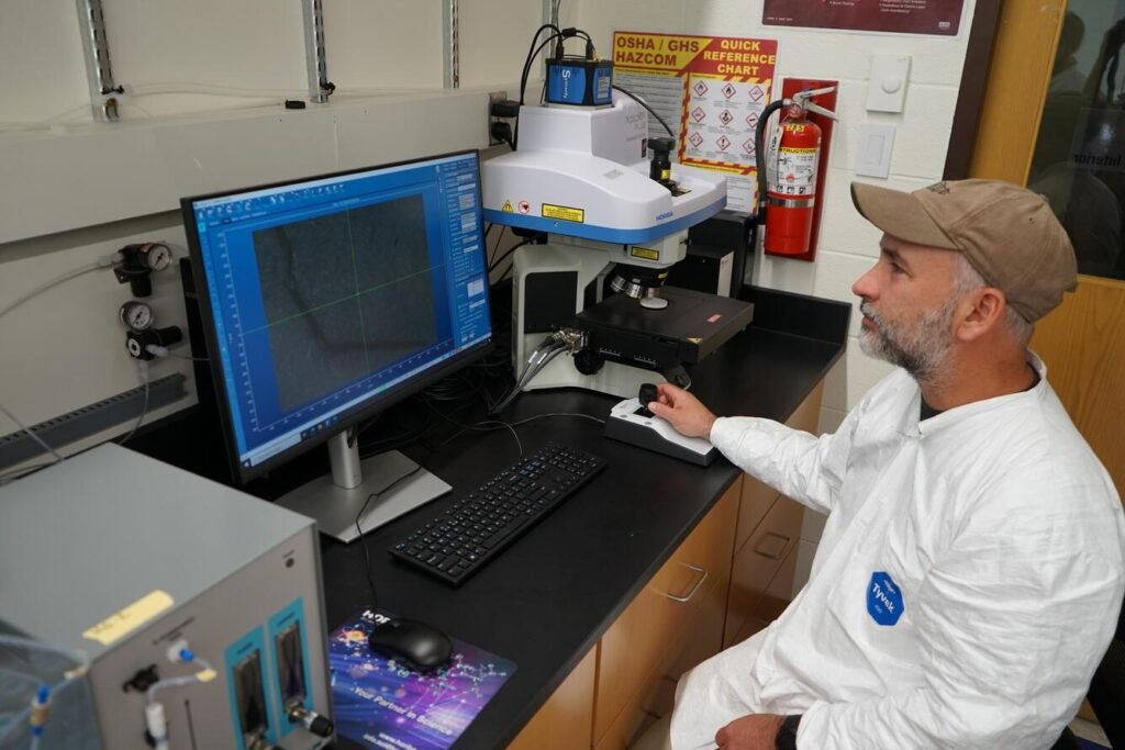USGS scientist Michael Tate using a Raman microscope to identify and characterize microplastics
